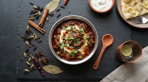 Kashmiri mutton rogan josh in a dark serving bowl